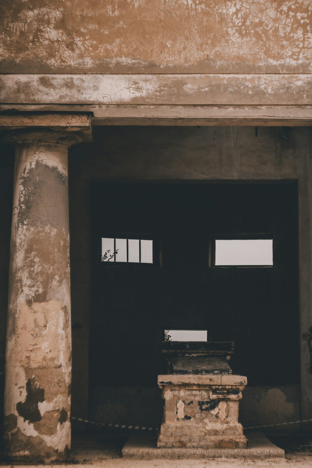 black wooden door on brown concrete wall