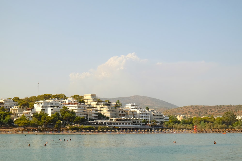 white and brown buildings near body of water during daytime