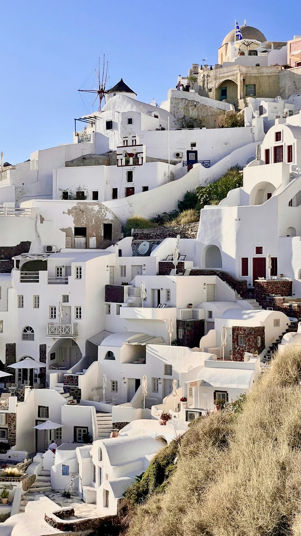 white concrete building on hill during daytime