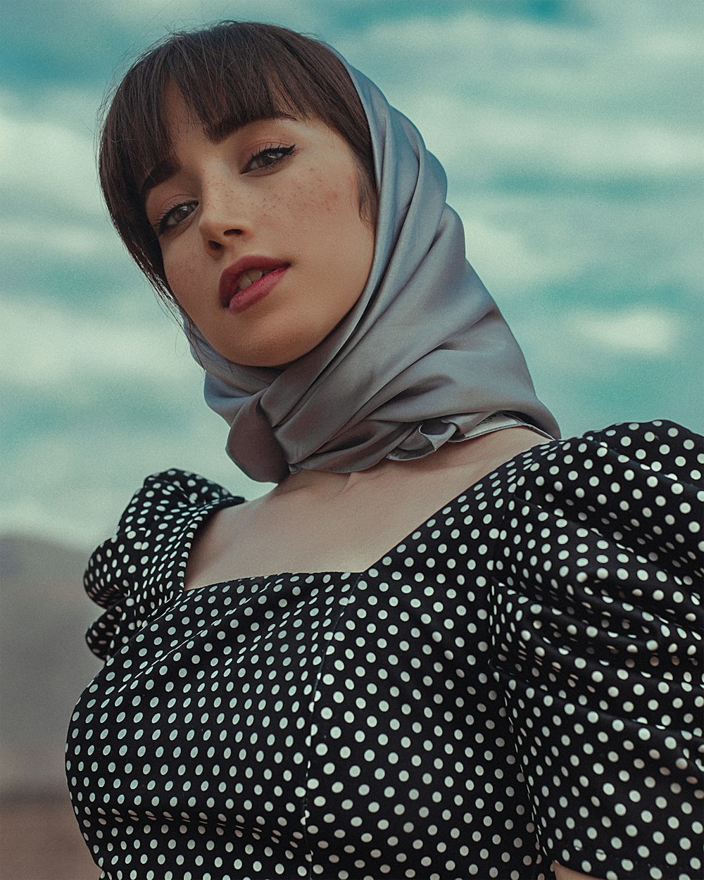 woman in black and white polka dot dress