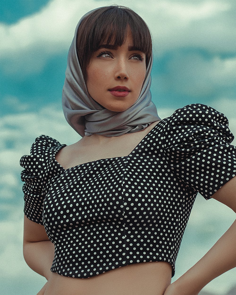 woman in black and white polka dot dress wearing white hijab