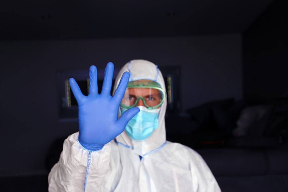 man in white zip up jacket wearing blue goggles