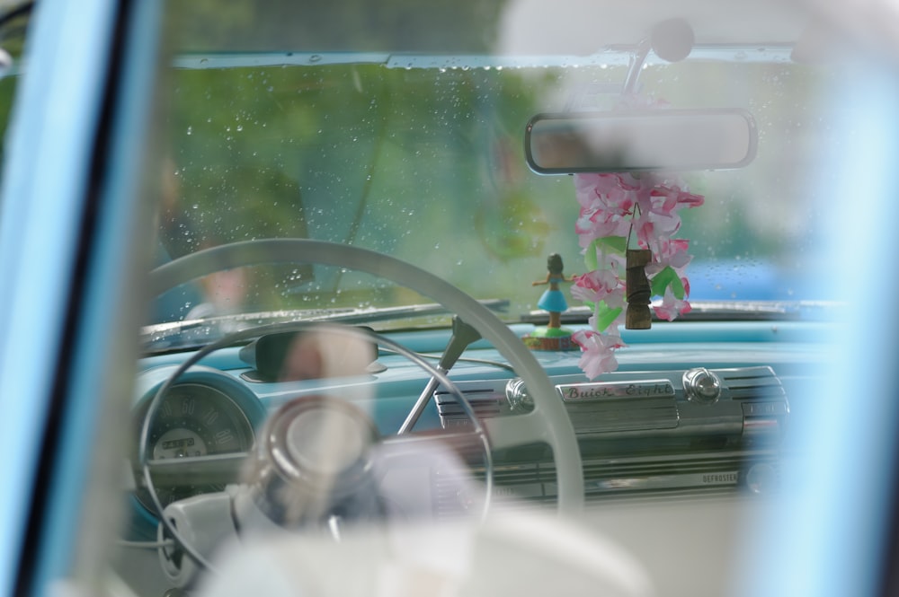 pink flowers in car during daytime