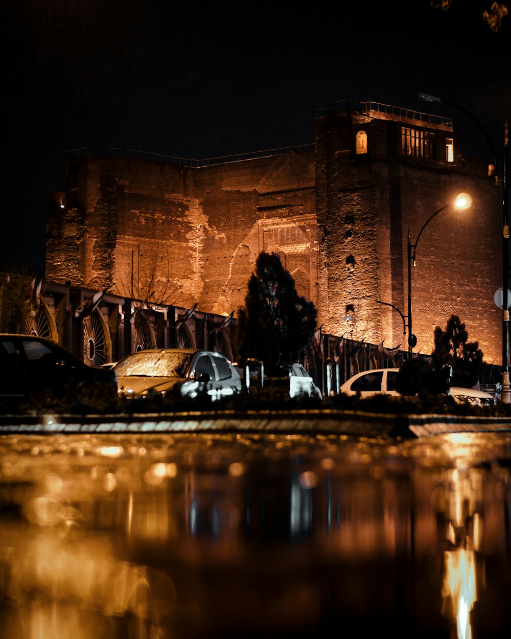 people sitting on bench near building during night time