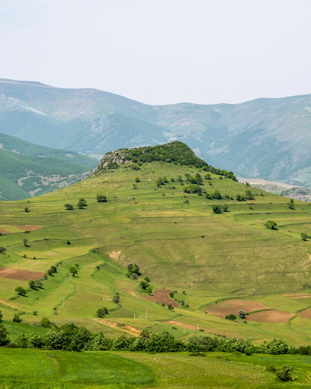 green grass field and mountains during daytime