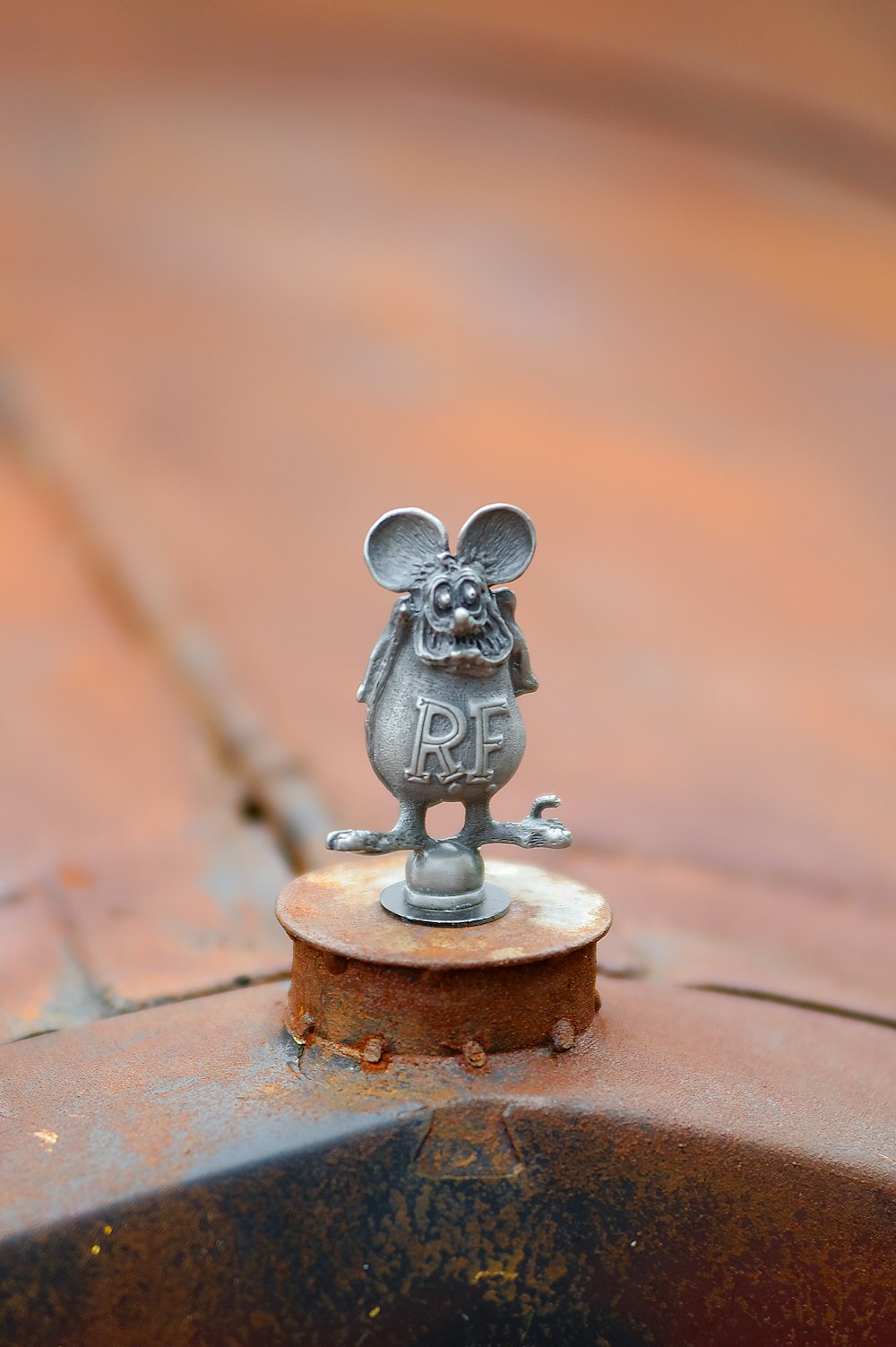 gray cat figurine on brown wooden table