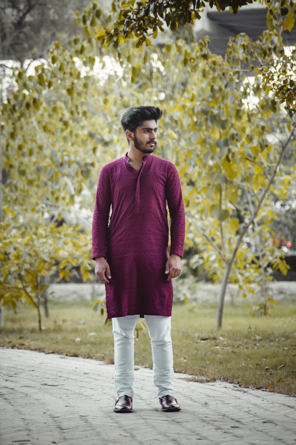 Man in a red sweater and white trousers