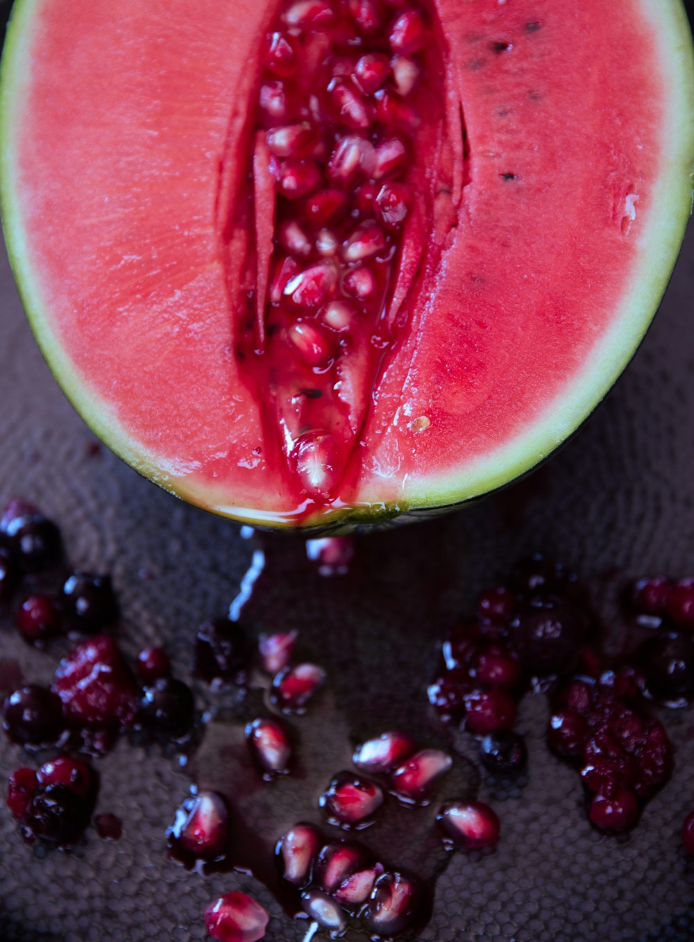 sliced watermelon on gray textile