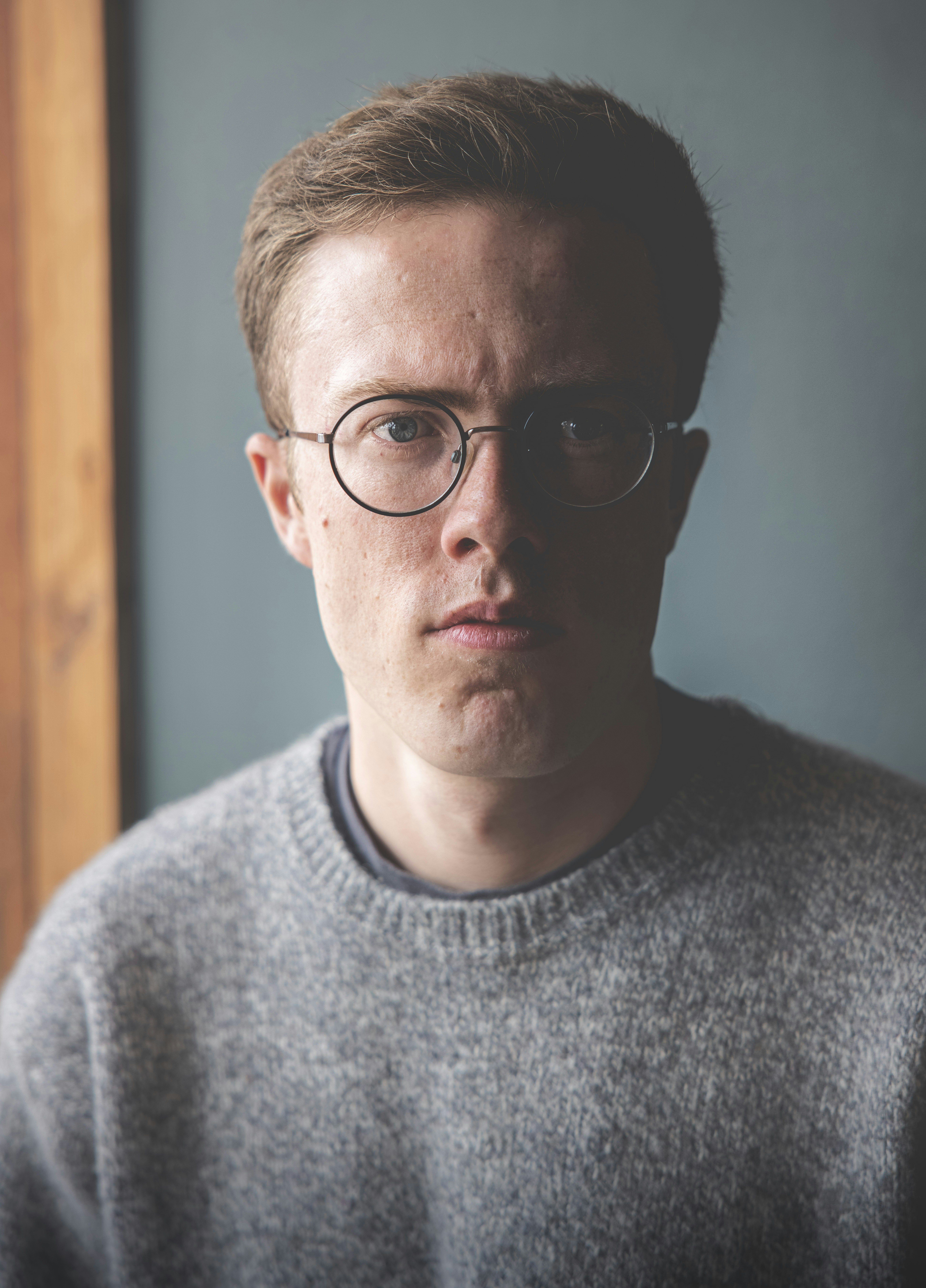 man in gray crew neck shirt wearing black framed eyeglasses