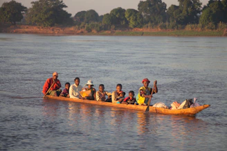people riding on kayak on body of water during daytime