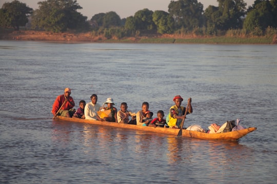 people riding on kayak on body of water during daytime in Belo Tsiribihina Madagascar