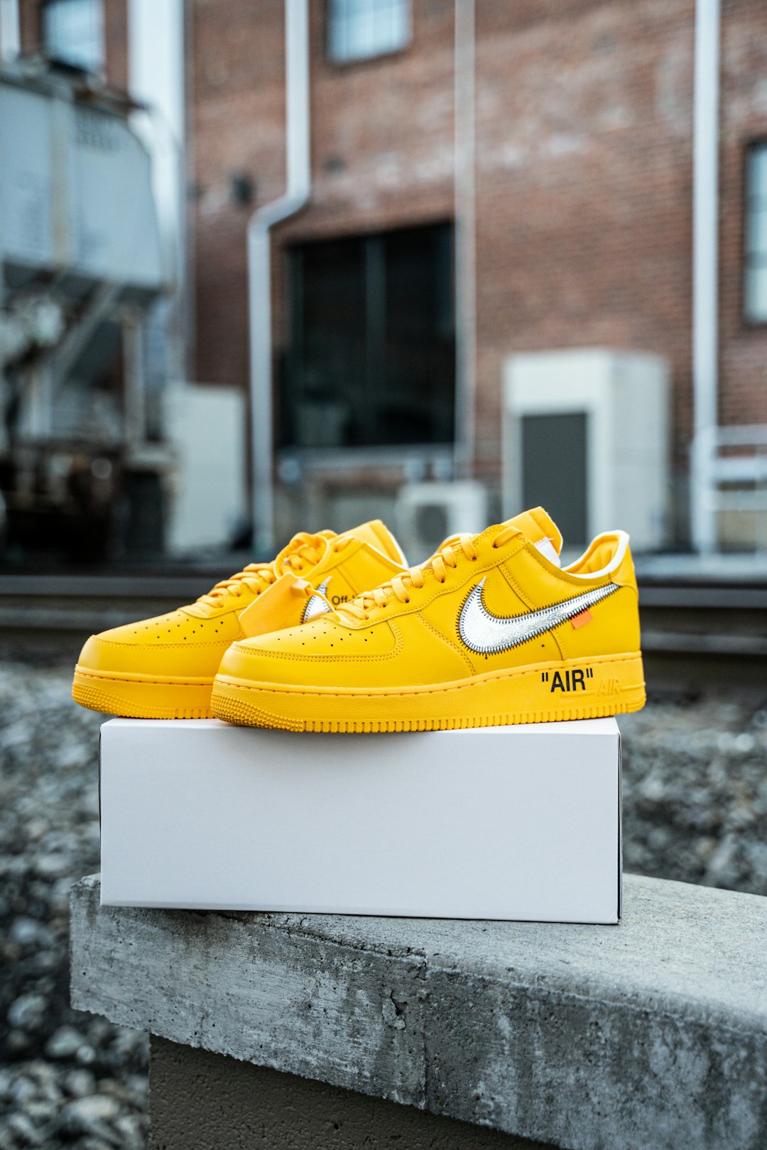 yellow nike athletic shoes on white box