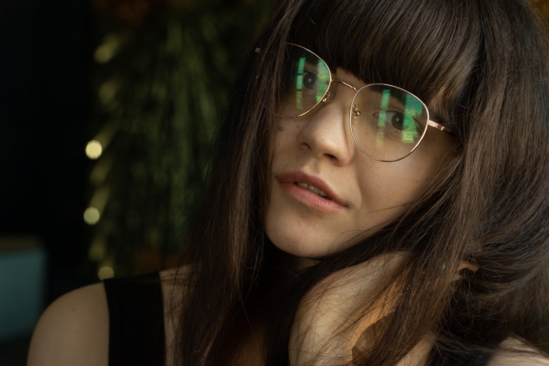 woman in black tank top wearing silver framed aviator sunglasses