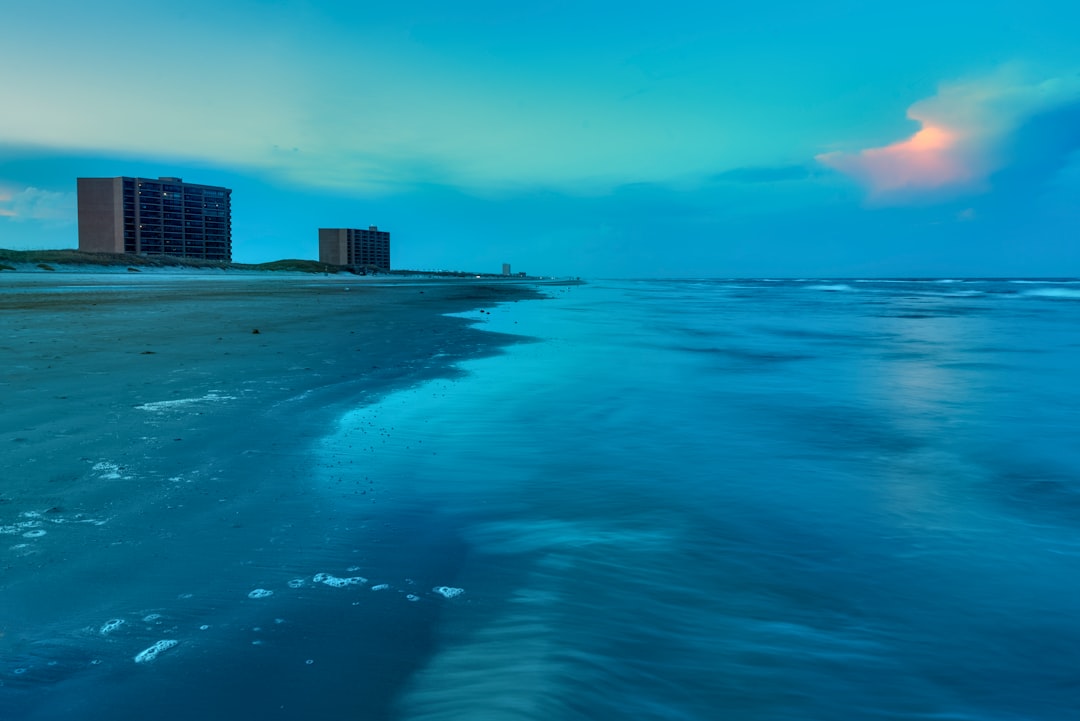 high rise building near sea under blue sky