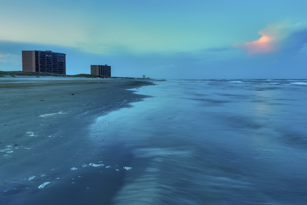 high rise building near sea under blue sky