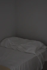 Simple non-AC single room featuring a single bed and basic comforts.