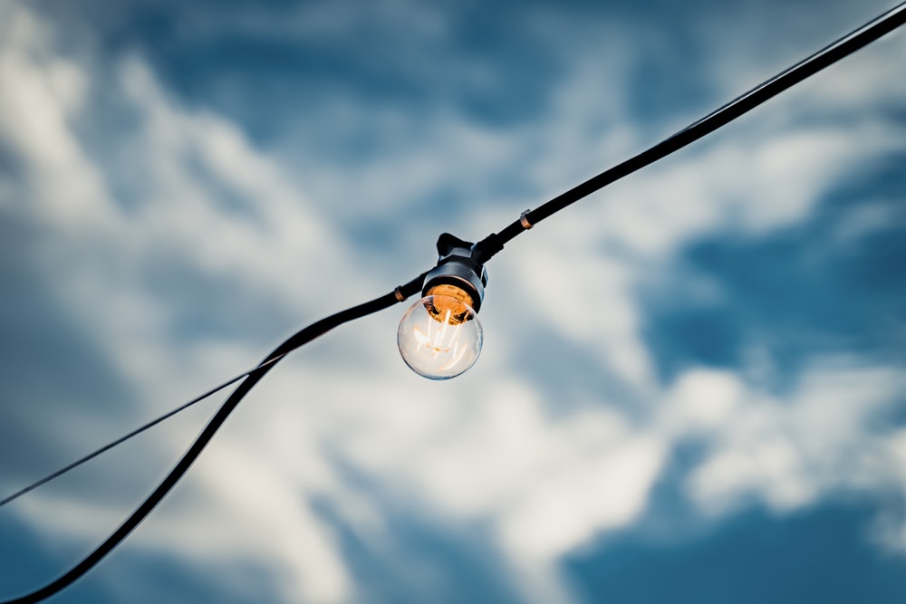 white light bulb under blue sky during daytime