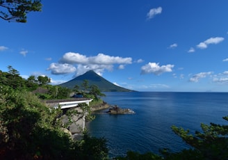white building near body of water under blue sky during daytime