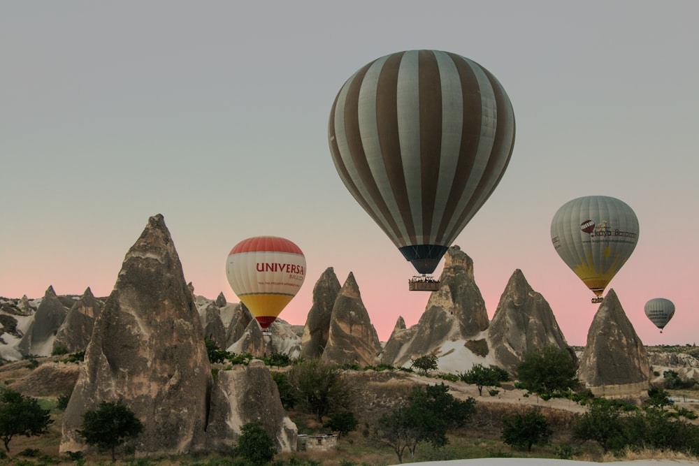 red and white hot air balloons on mid air during daytime