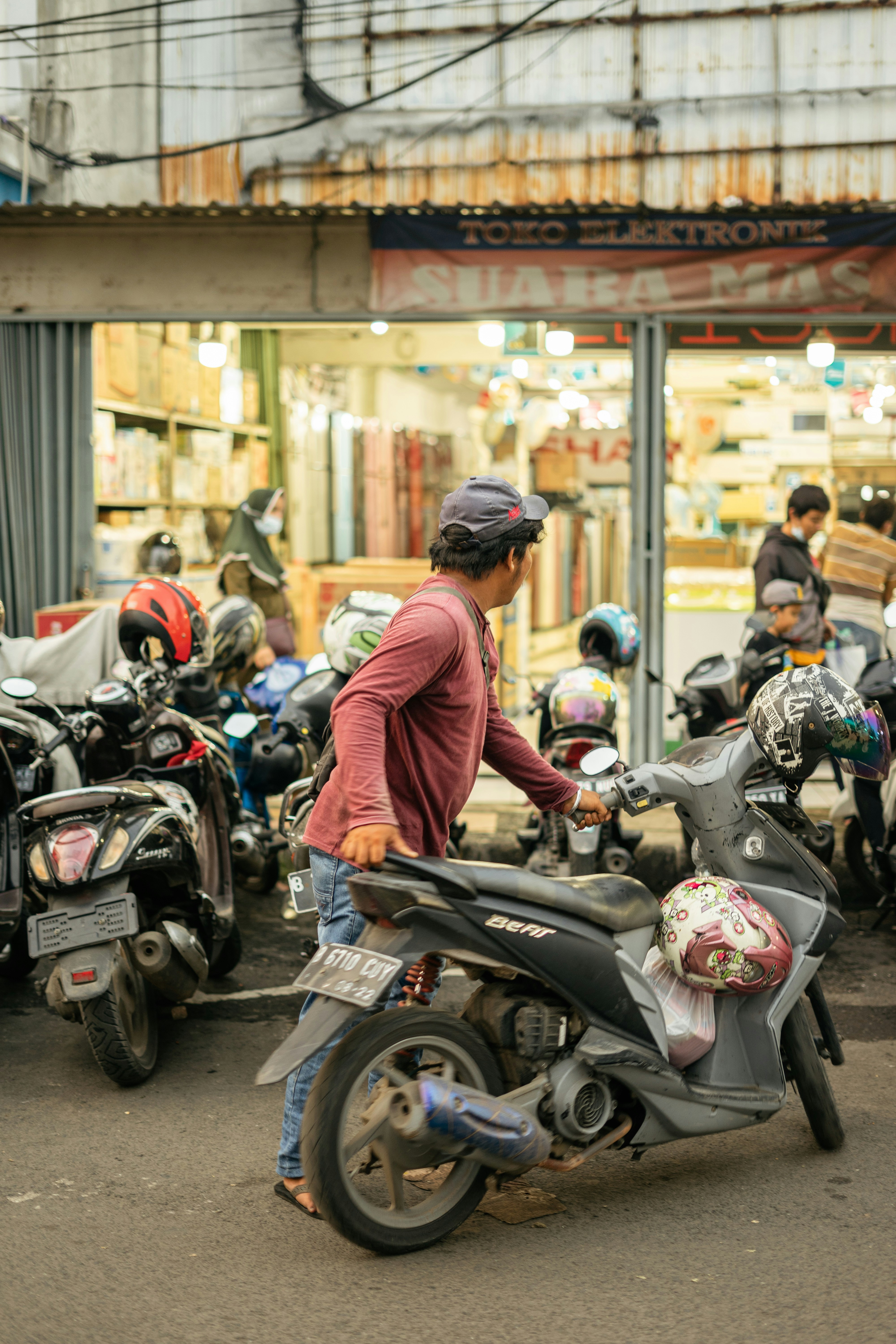 man in red jacket riding motorcycle
