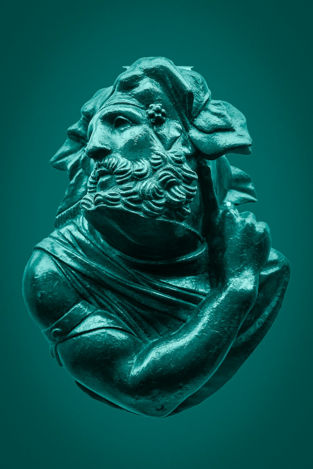 green concrete statue of man