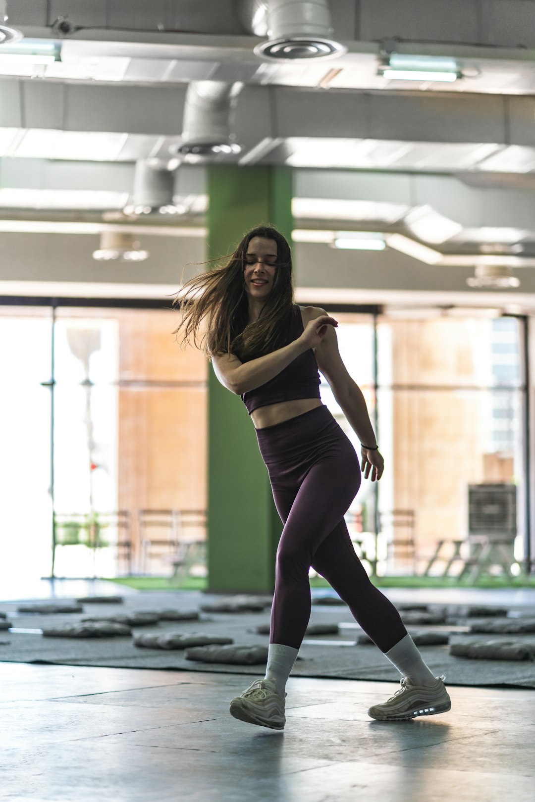 woman in black tank top and black leggings doing yoga