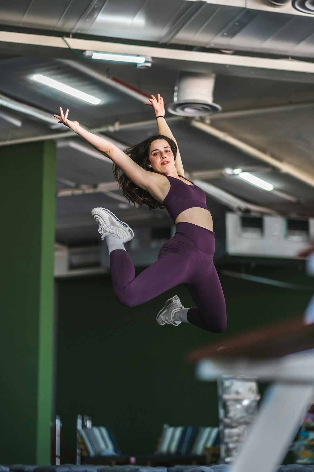 woman in purple sports bra and purple leggings doing yoga