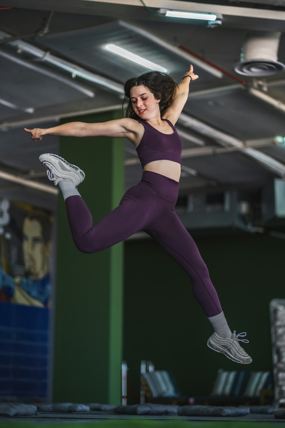 woman in black sports bra and purple leggings doing yoga