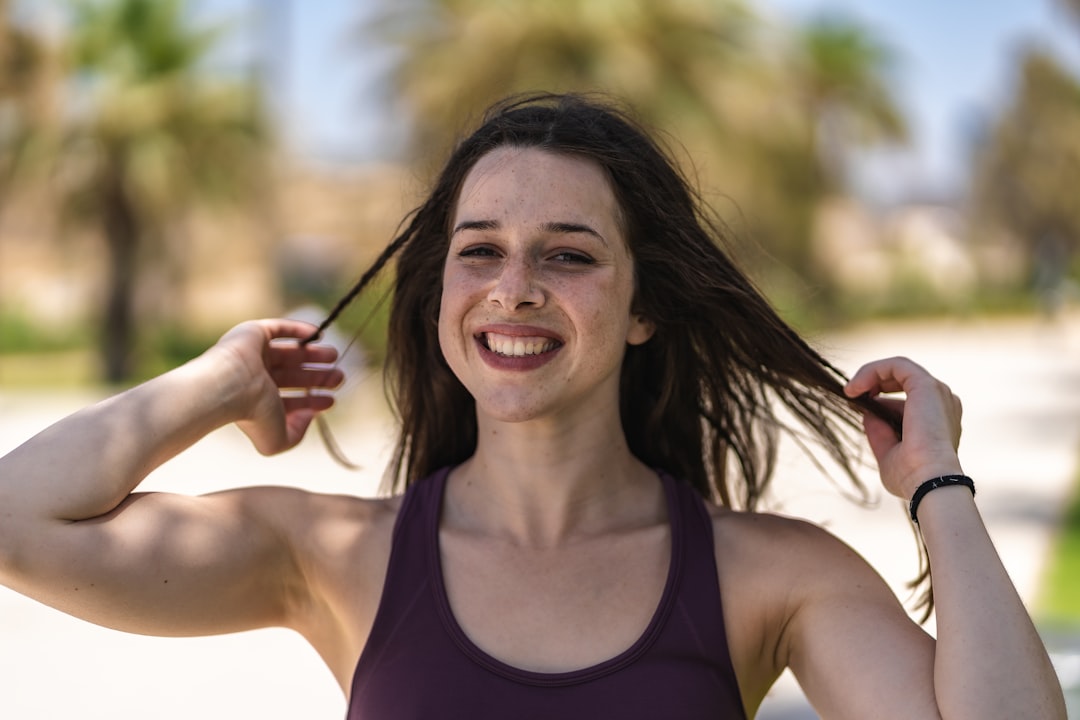 woman in black tank top smiling