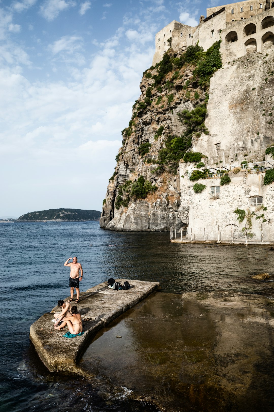 woman in black bikini sitting on brown wooden dock during daytime