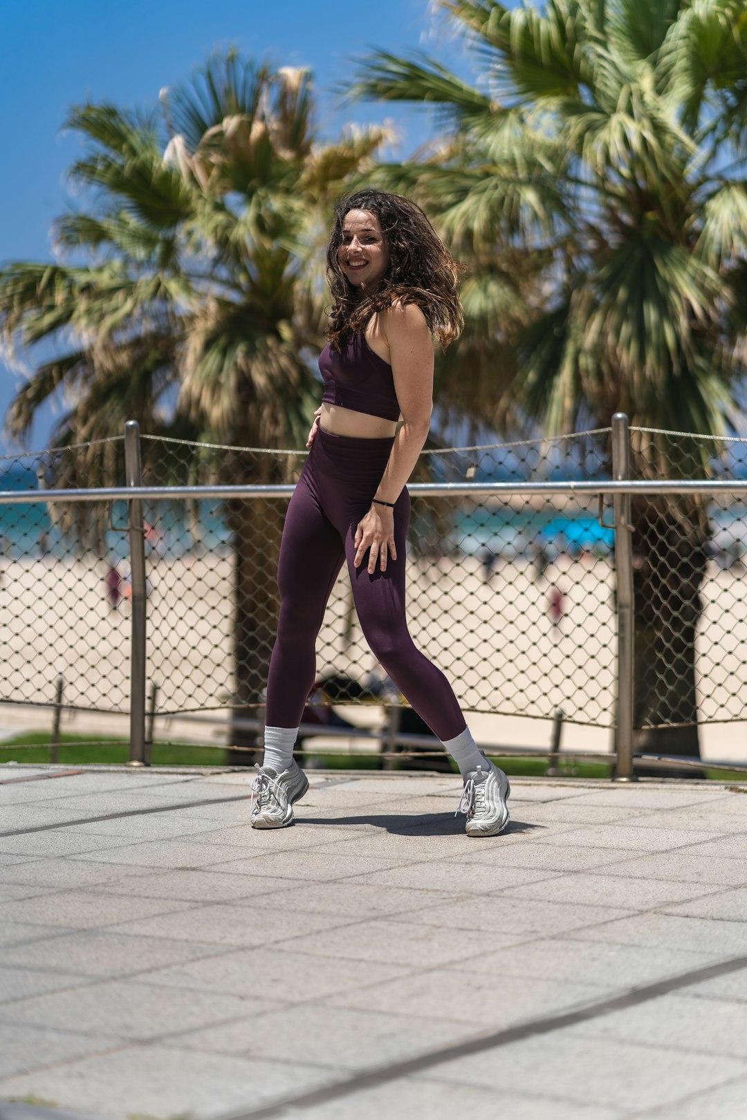 woman in black sports bra and purple leggings doing yoga during daytime