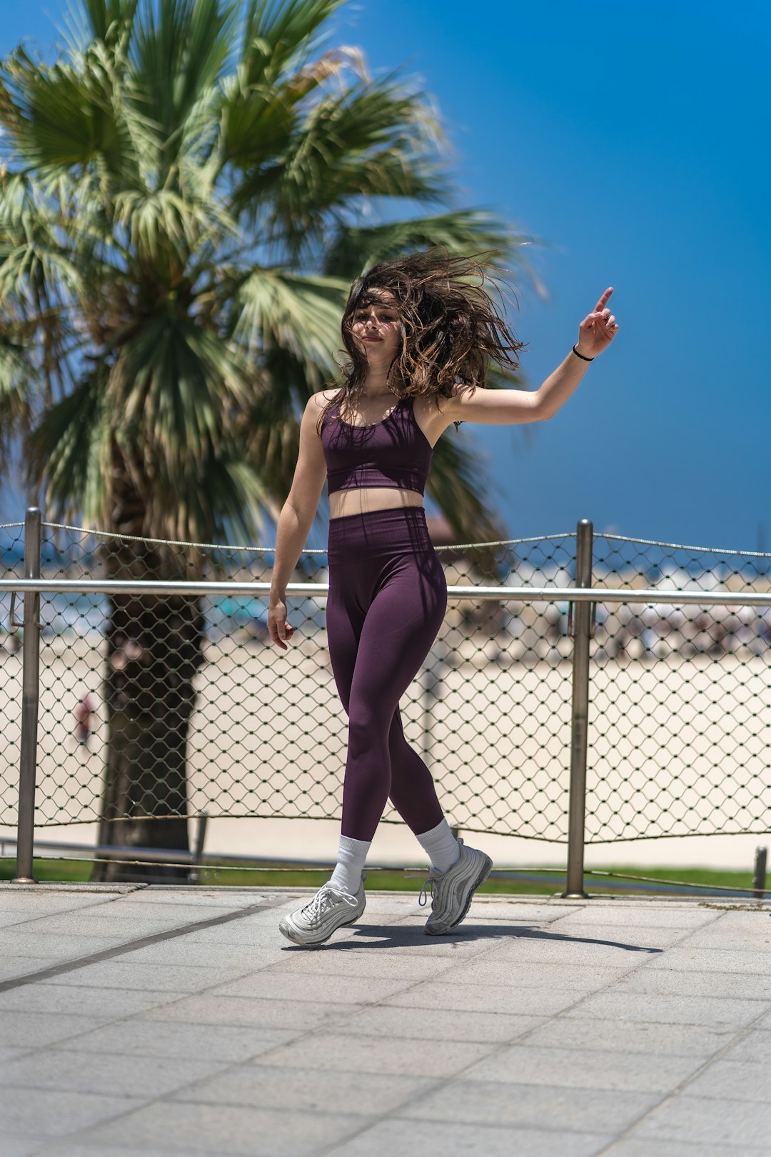 woman in black sports bra and purple leggings doing yoga during daytime