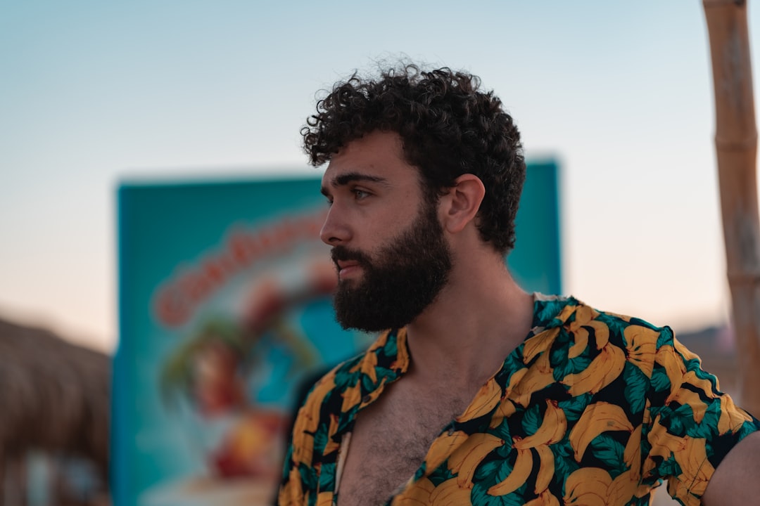 man in blue and yellow floral shirt