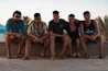 group of people sitting on brown sand during daytime
