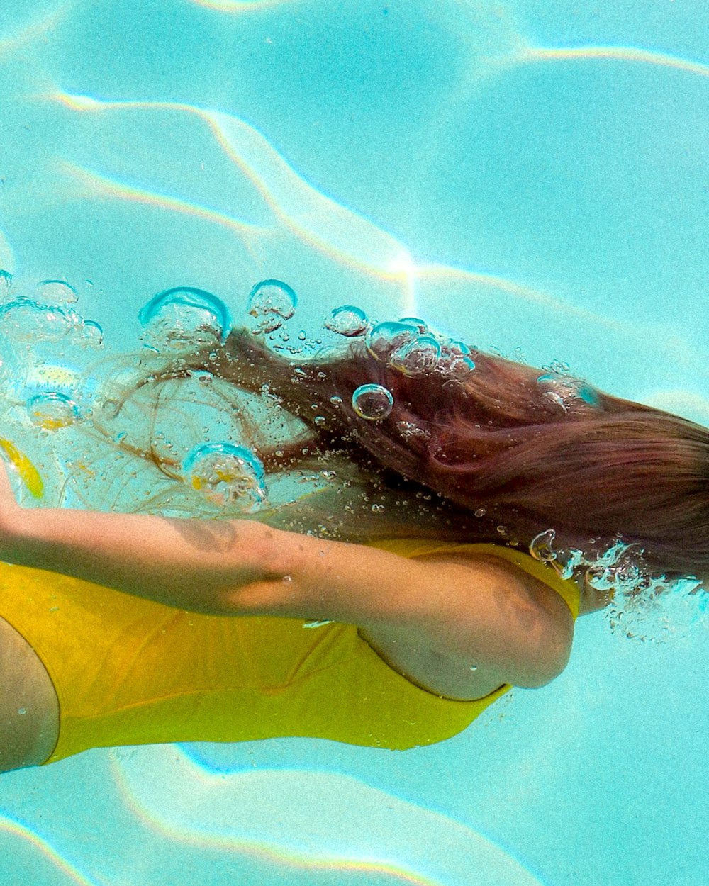 woman in yellow tank top swimming in water
