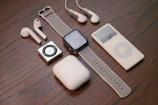 white apple earpods beside white ipod nano