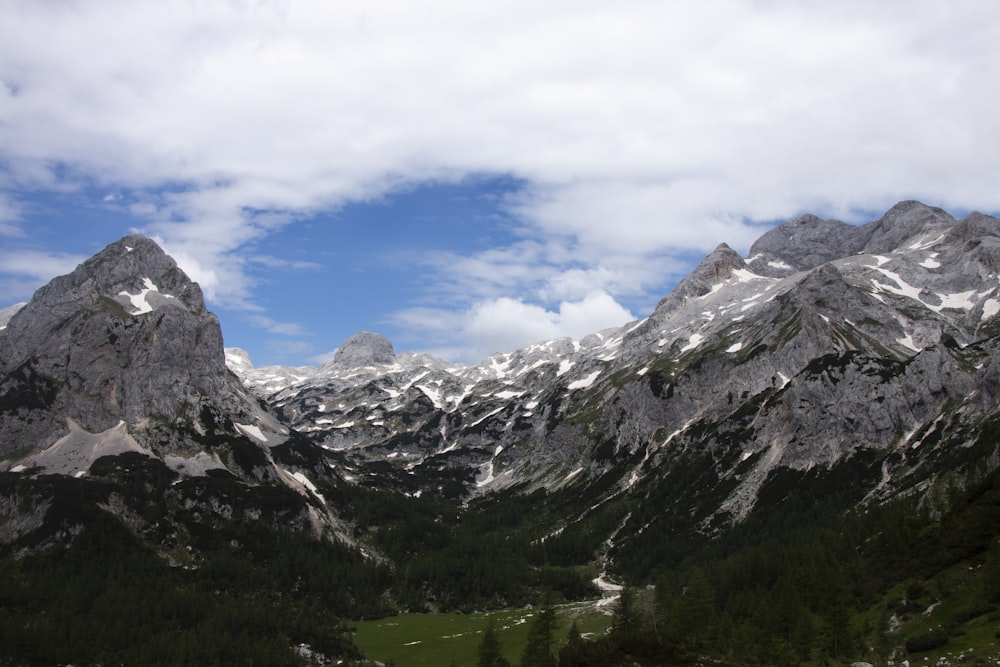 green and white mountains under blue sky and white clouds during daytime