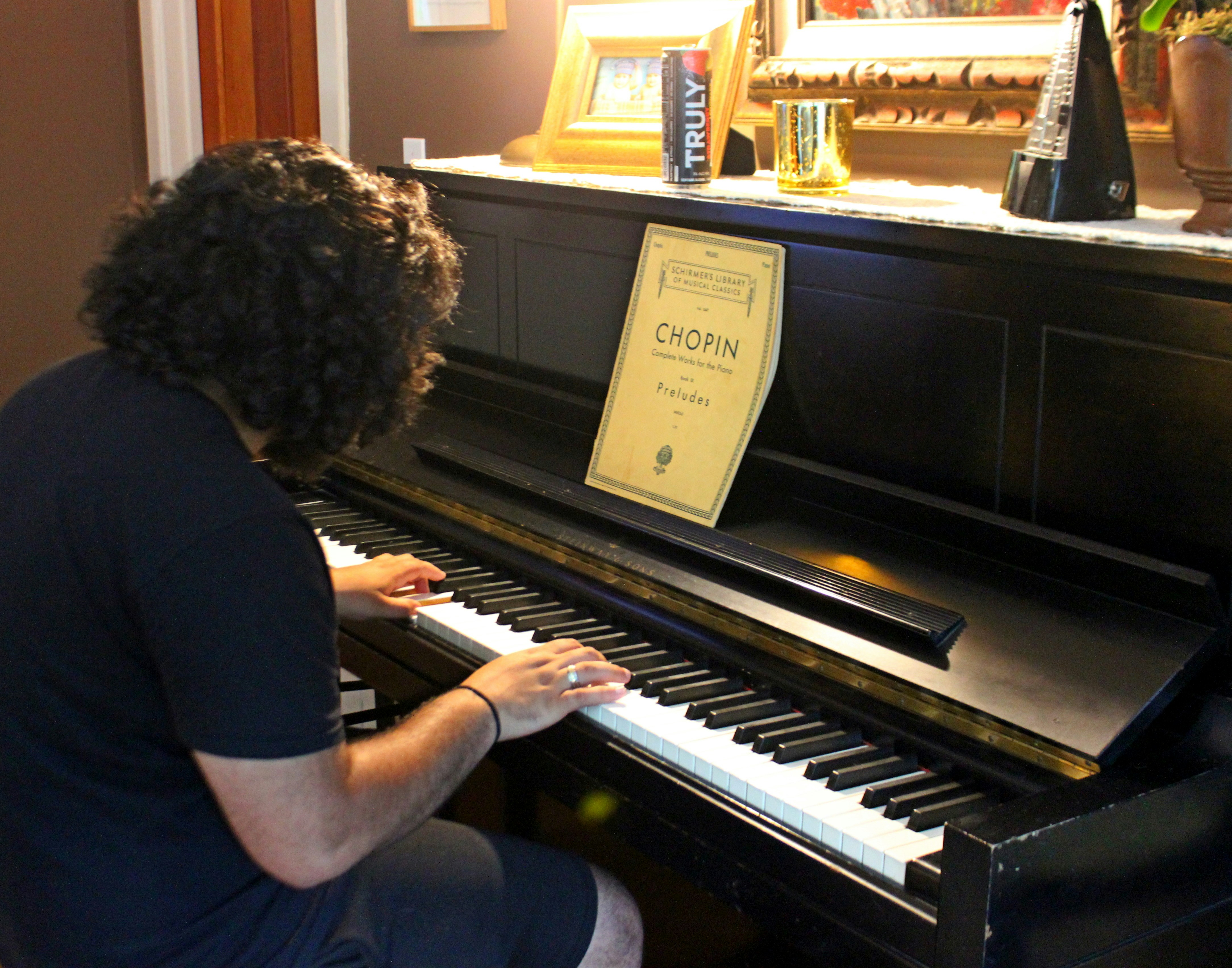woman in black shirt playing piano
