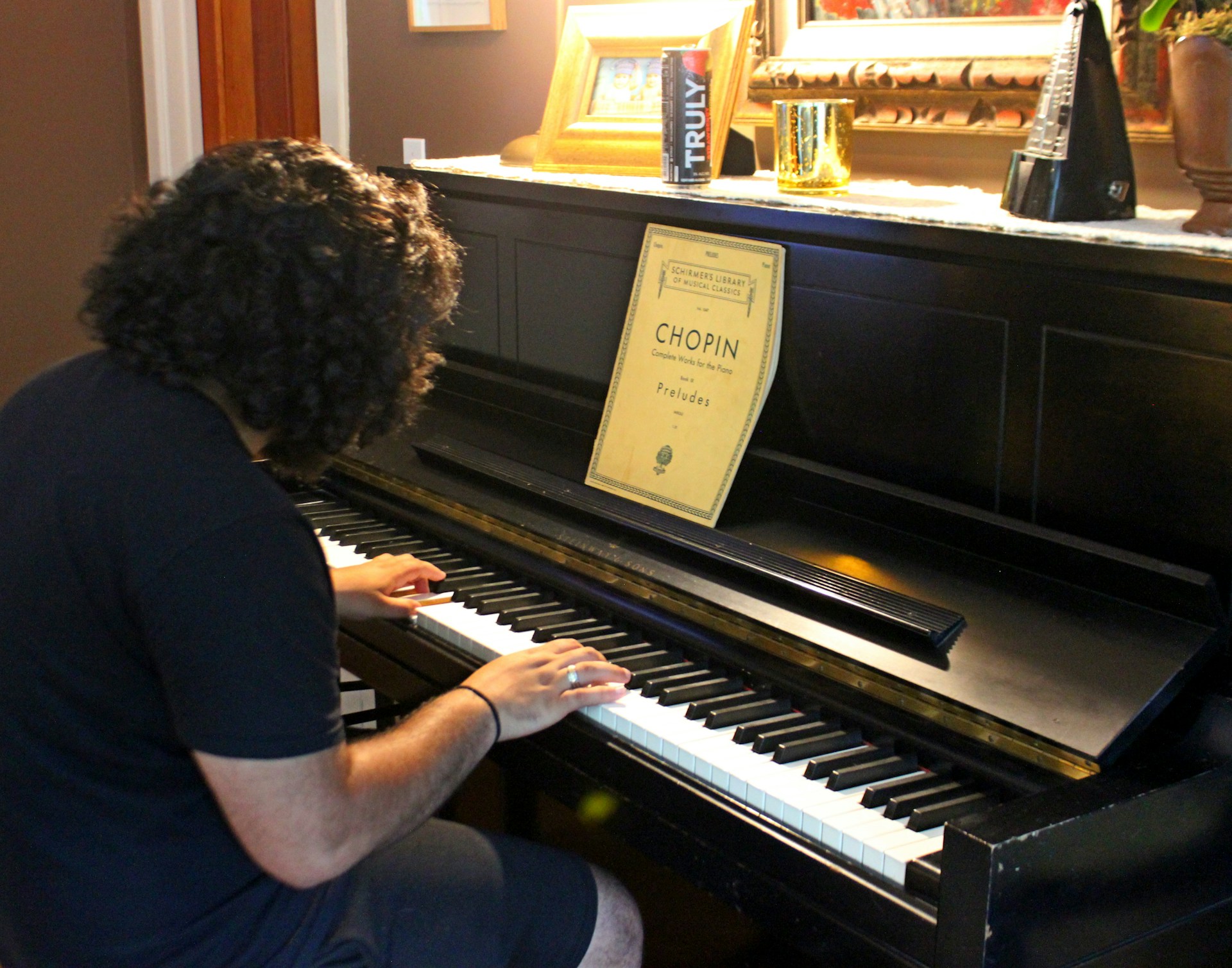 woman in black shirt playing piano