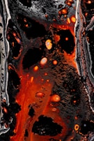 Abstract dark energy patterns swirling with magma-orange highlights.