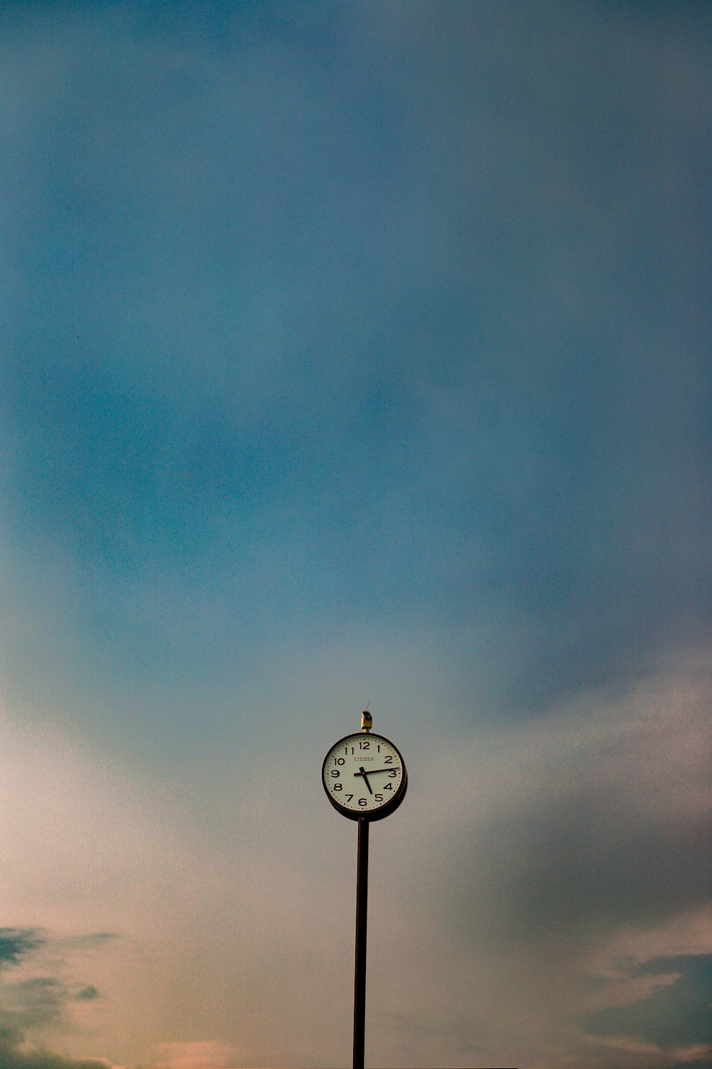 black and white street light under blue sky