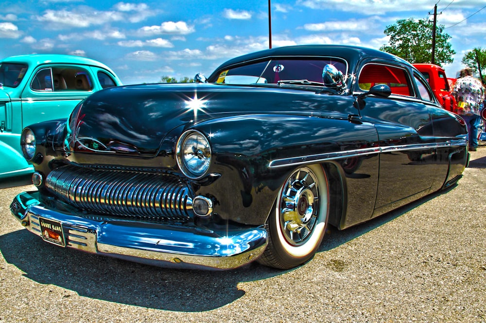 blue classic car on grey concrete road during daytime