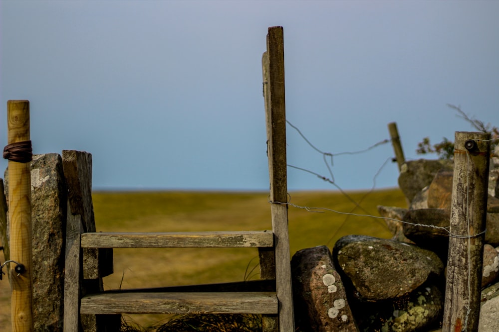 brown wooden fence on gray rock