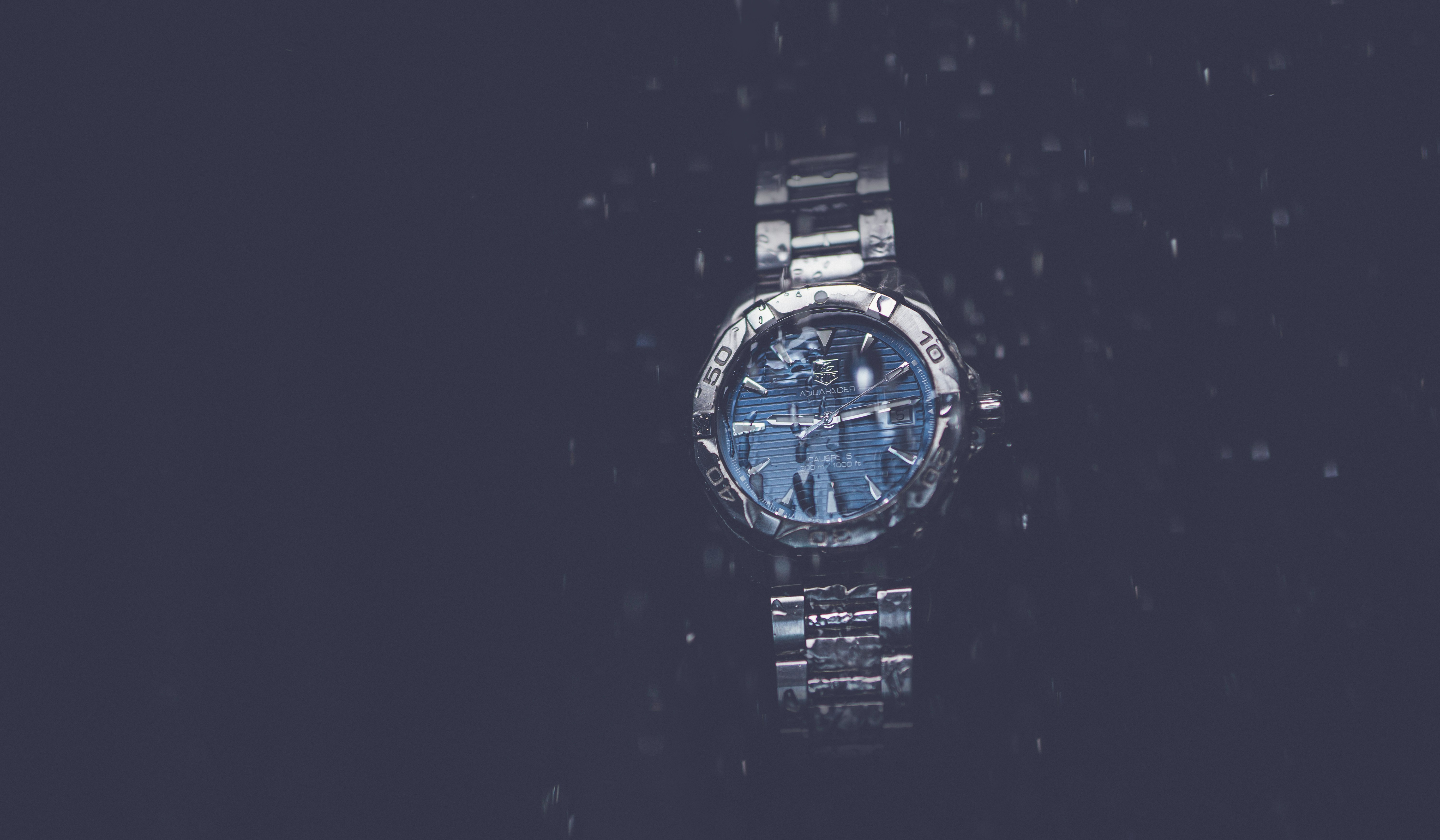 silver and blue round analog watch