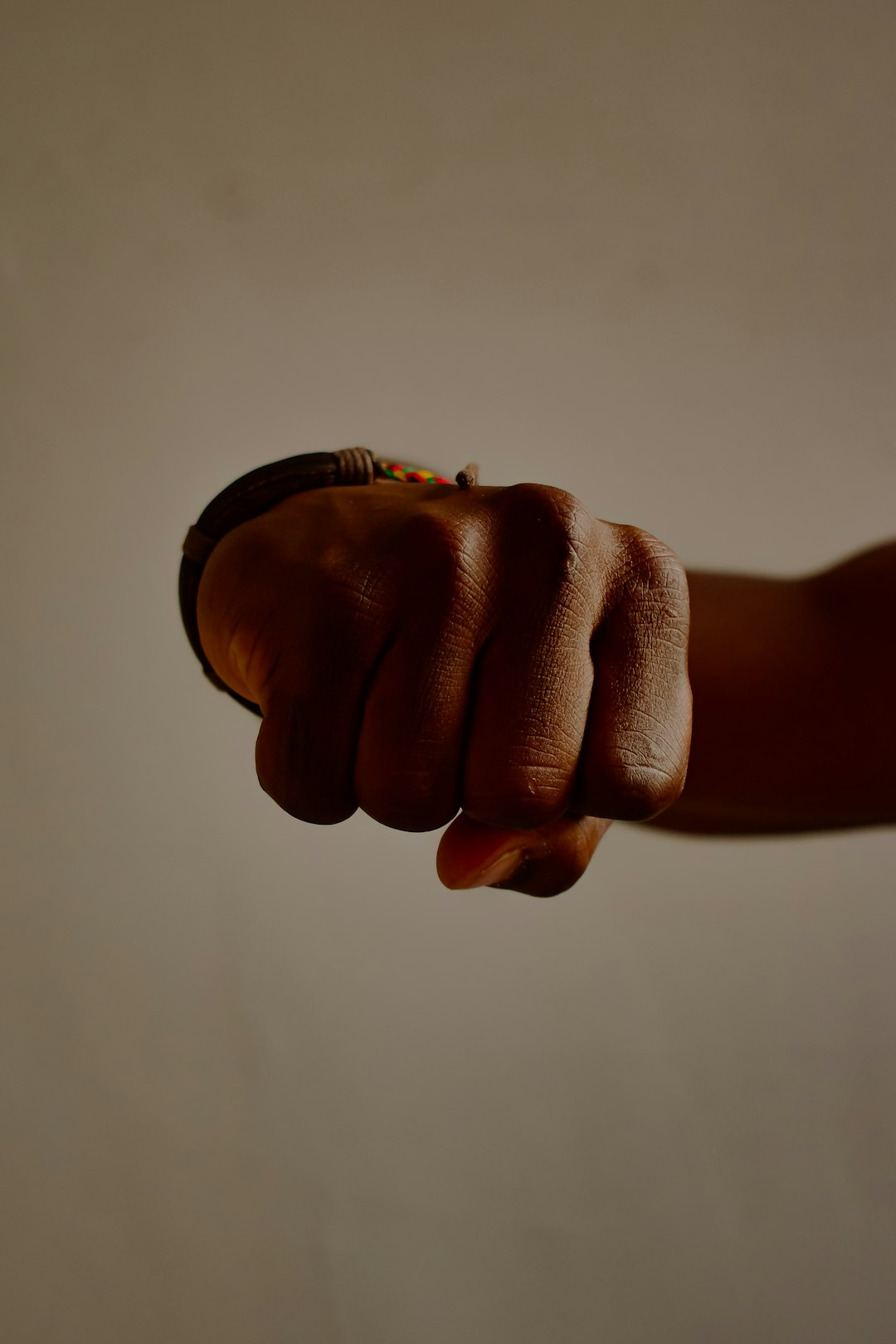 person wearing black and gold ring