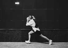 grayscale photo of woman in white shirt and black shorts