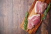 raw meat on brown wooden chopping board