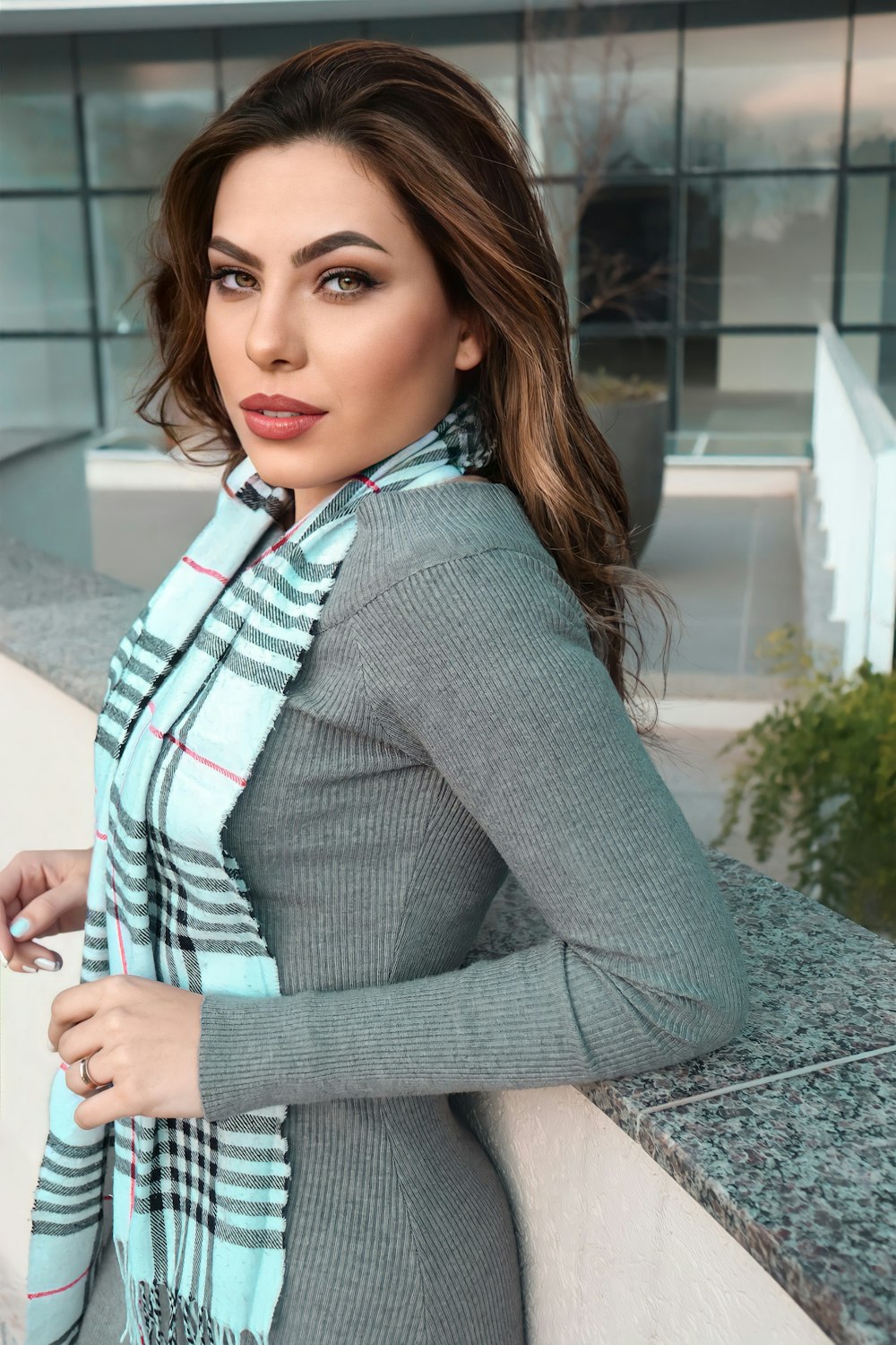 woman in gray blazer and red white plaid shirt