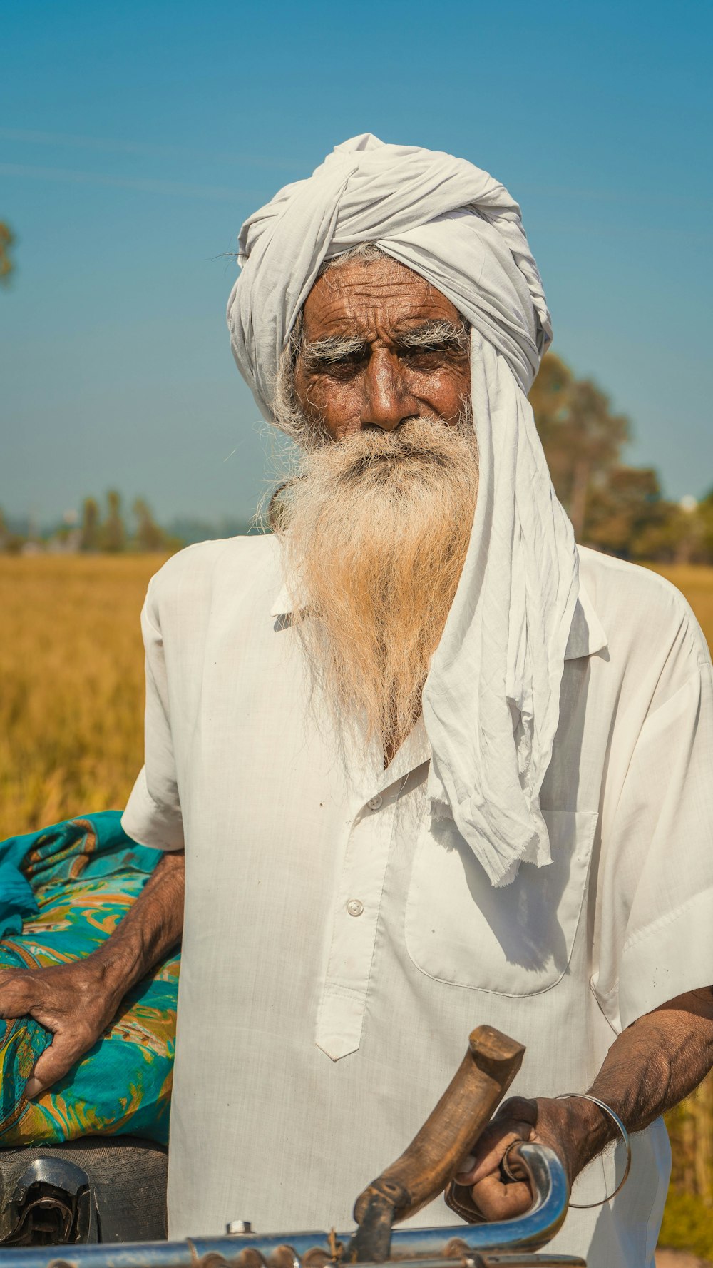 man in white thobe standing on green grass field during daytime