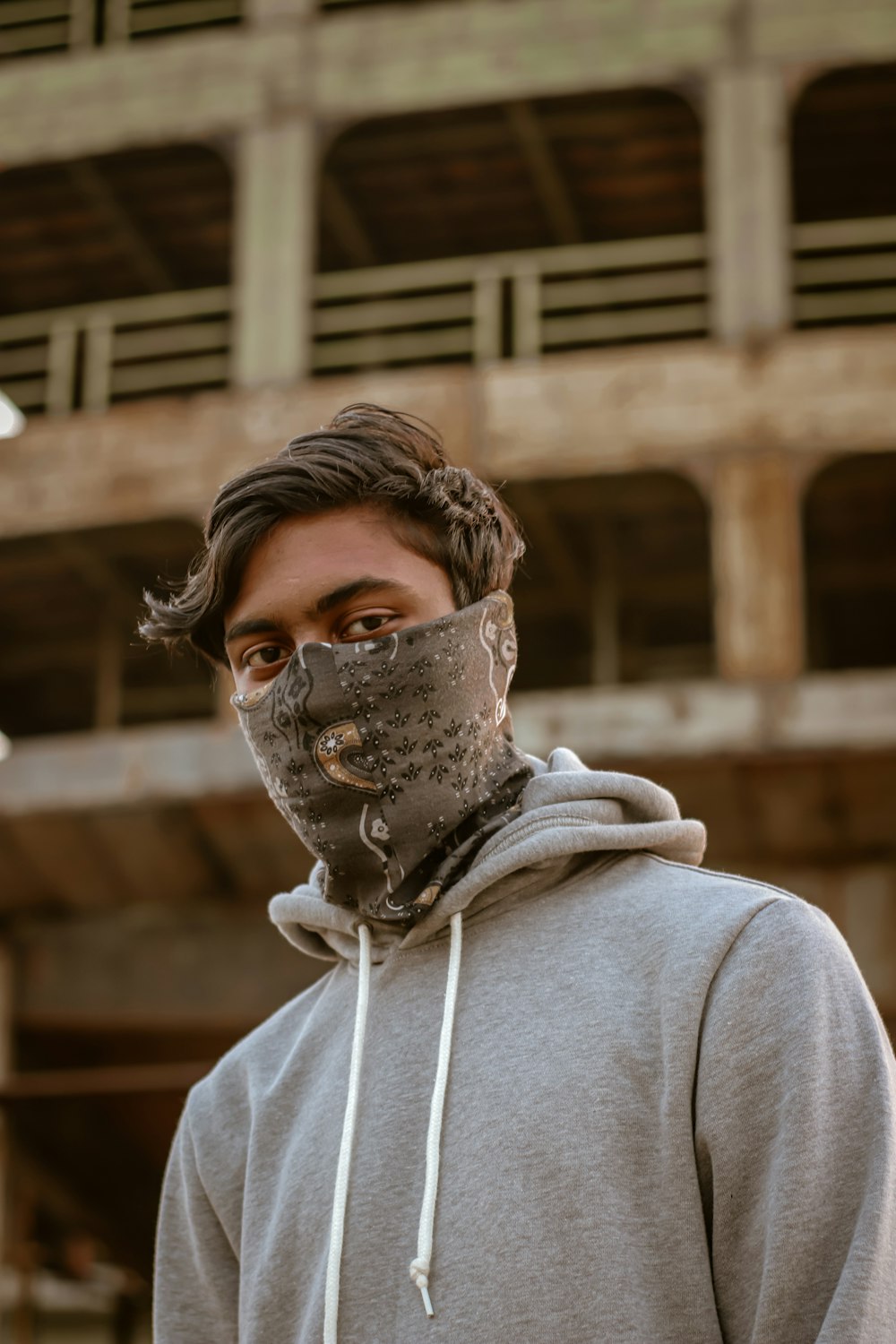 man in gray hoodie wearing black mask